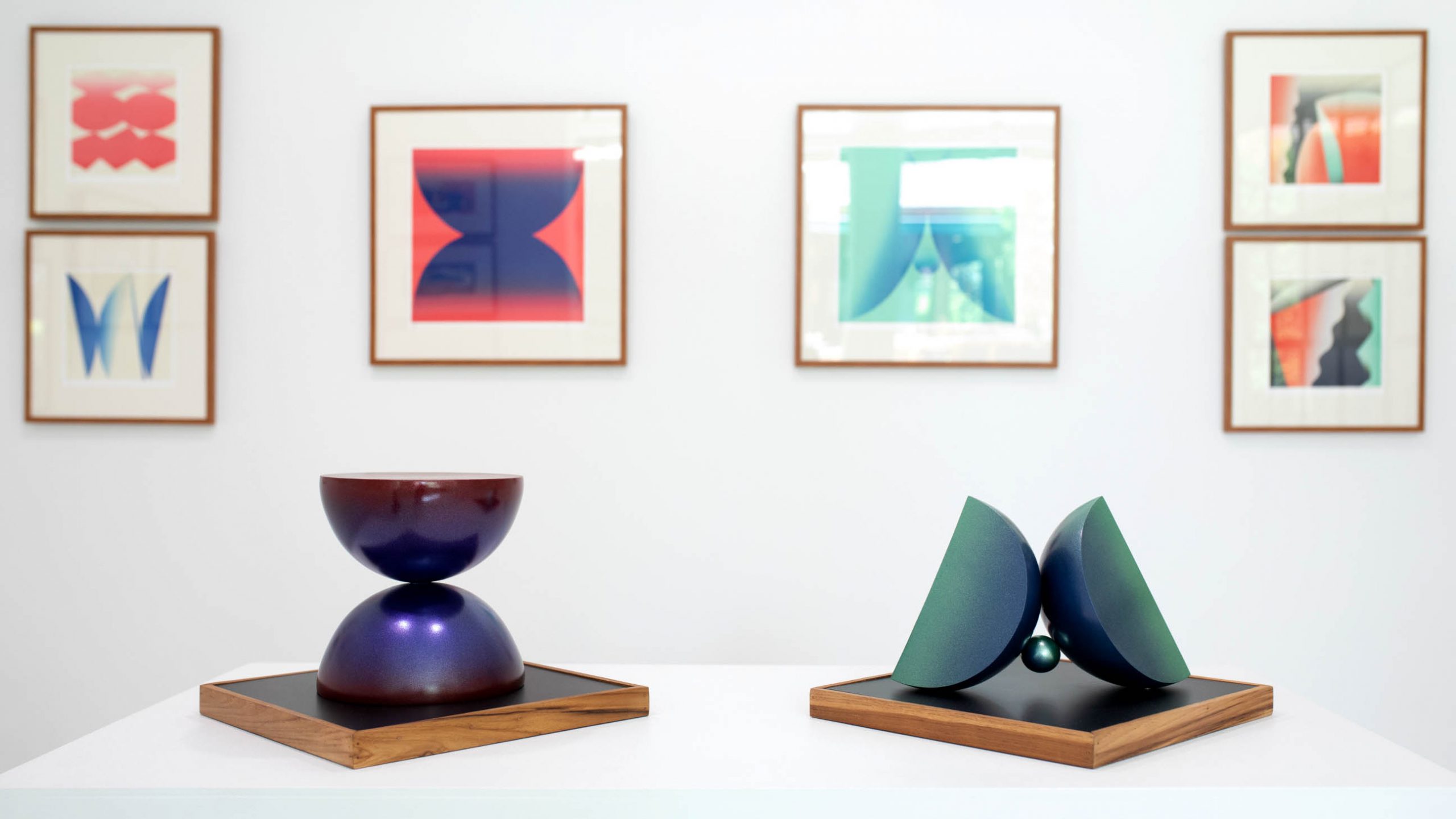 Geometric sculpture on the stands and minimalist art prints on white wall, art by narit tananon